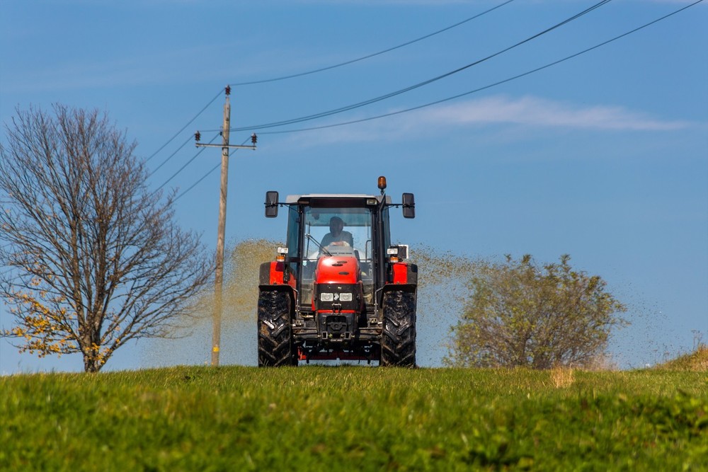 Traktor düngt mit Gülle ein Feld